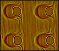 Click for high-res version: Template self-organization -- cylindrical pits on a silicon surface.