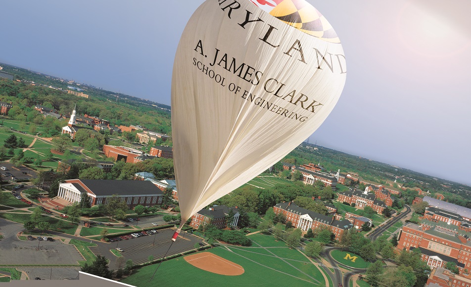 A white balloon over the University of Maryland campus with the A. James Clark School of Engineering logo on it
