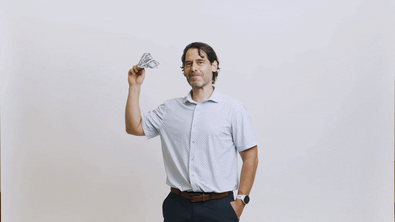 Christoph Brehm throws a paper airplane toward the camera