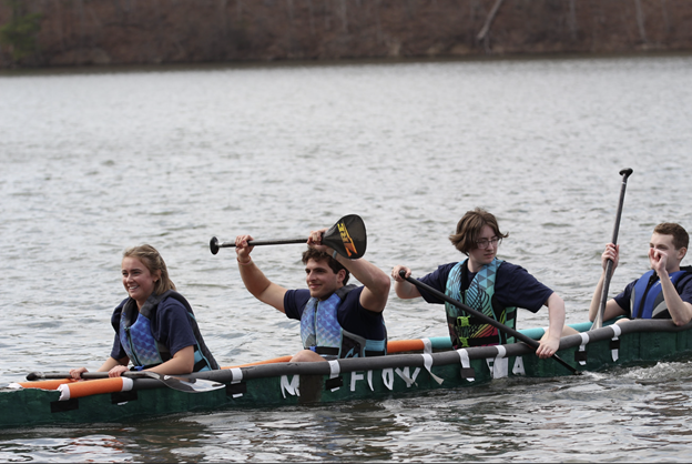Students paddle in a canoe