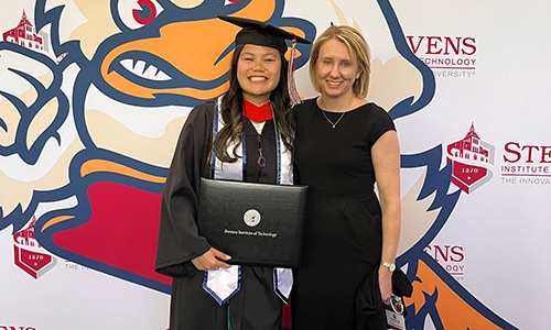 a Clark Scholar poses while holding their degree 