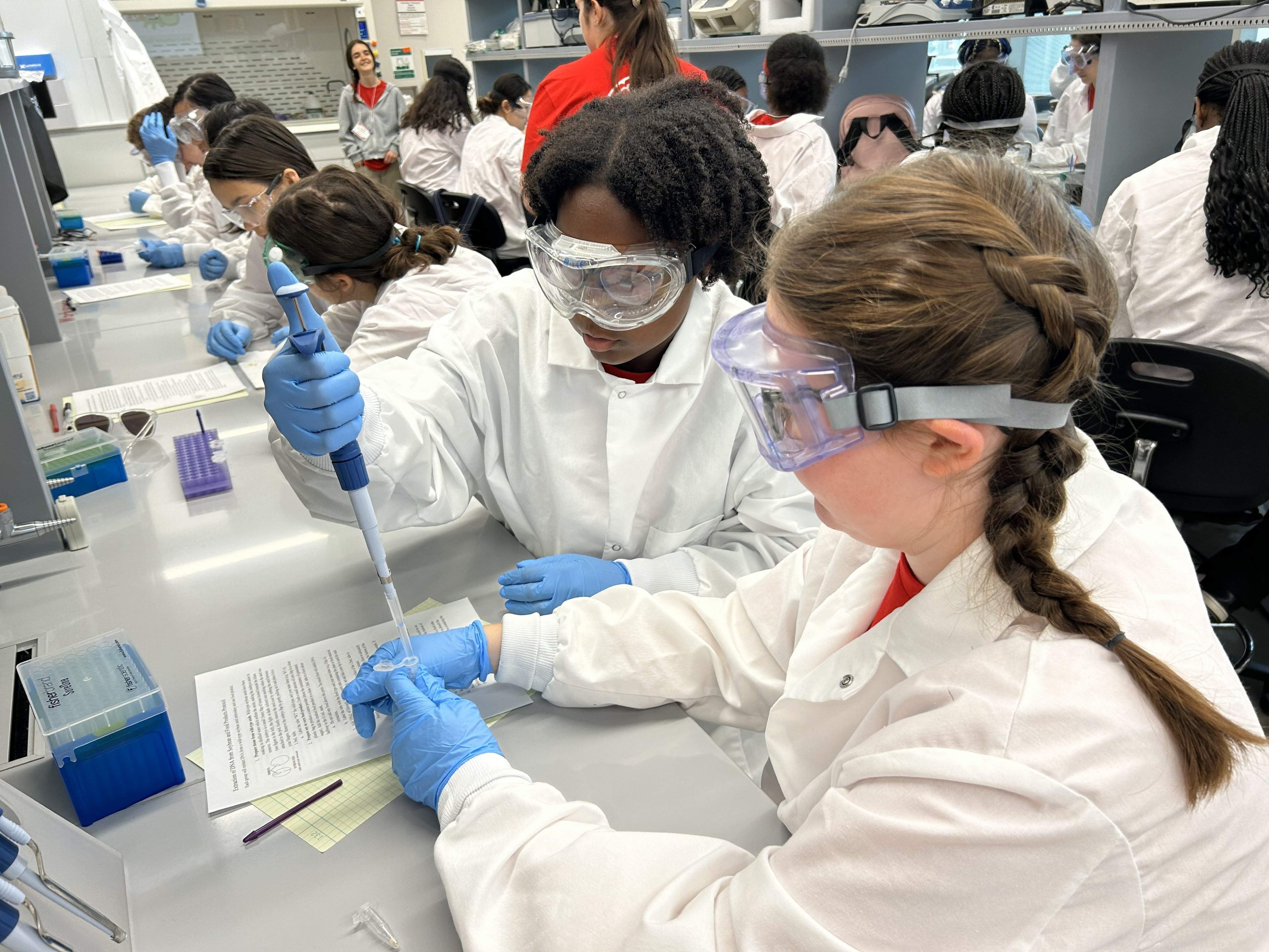 WIE summer program - Bioengineering students using a micropipette in a bioengineering session at a WIE summer program