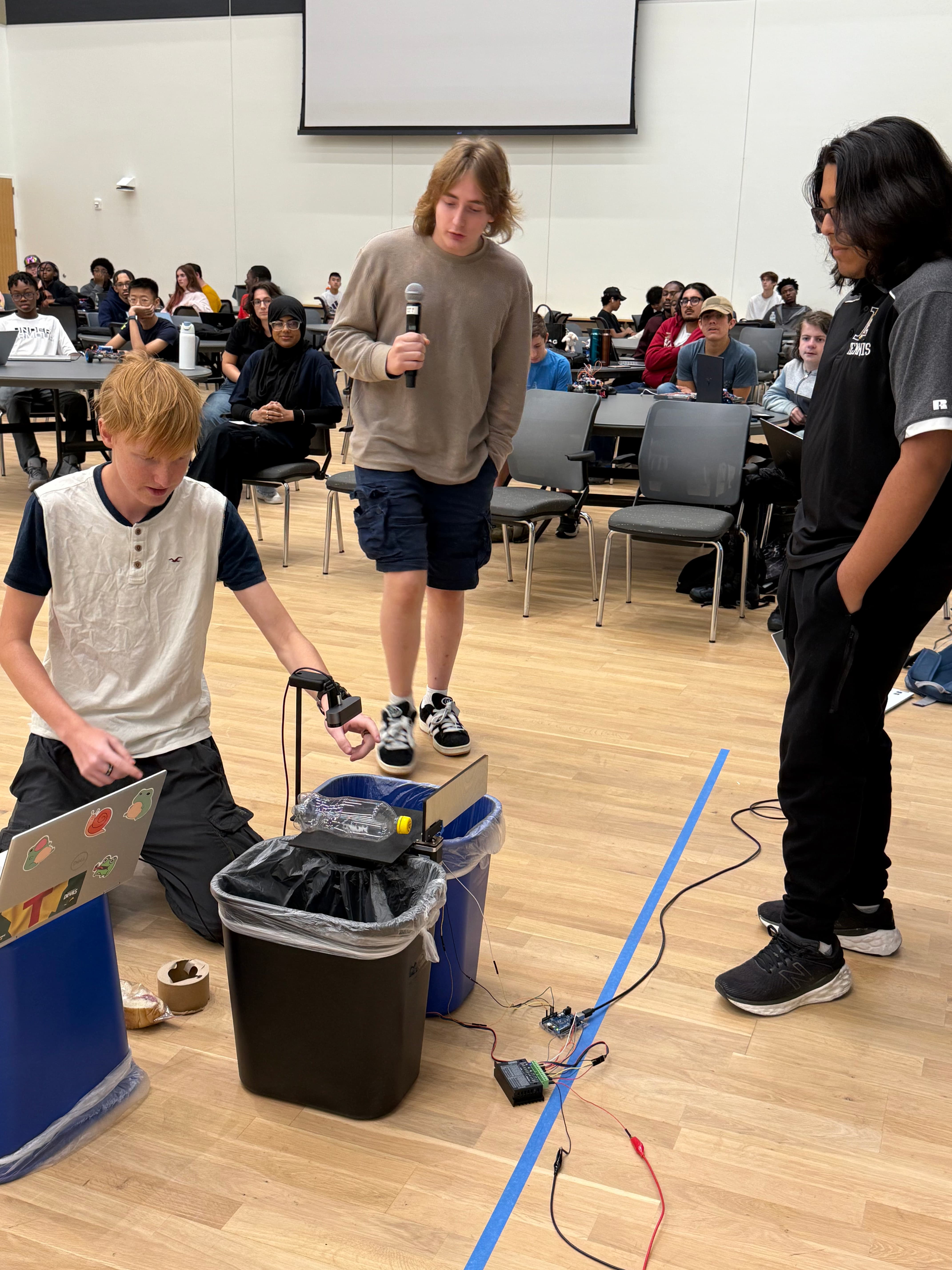 students presenting their recycling robot