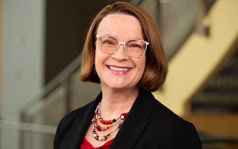 headshot of Jennifer Schwartz wearing glasses and smiling while looking directly at the camera