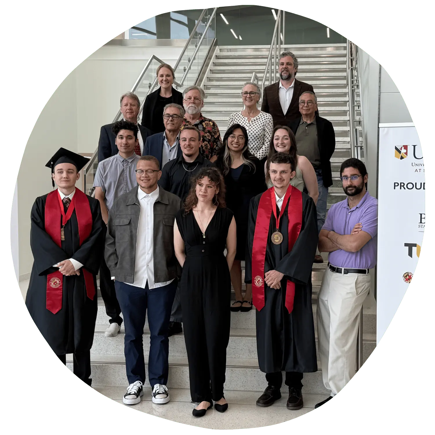 student graduates with faculty and industry partners