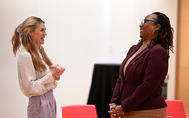female student laughs while speaking with Donya Douglas-Bradshaw, Project Manager for the Lucy Mission