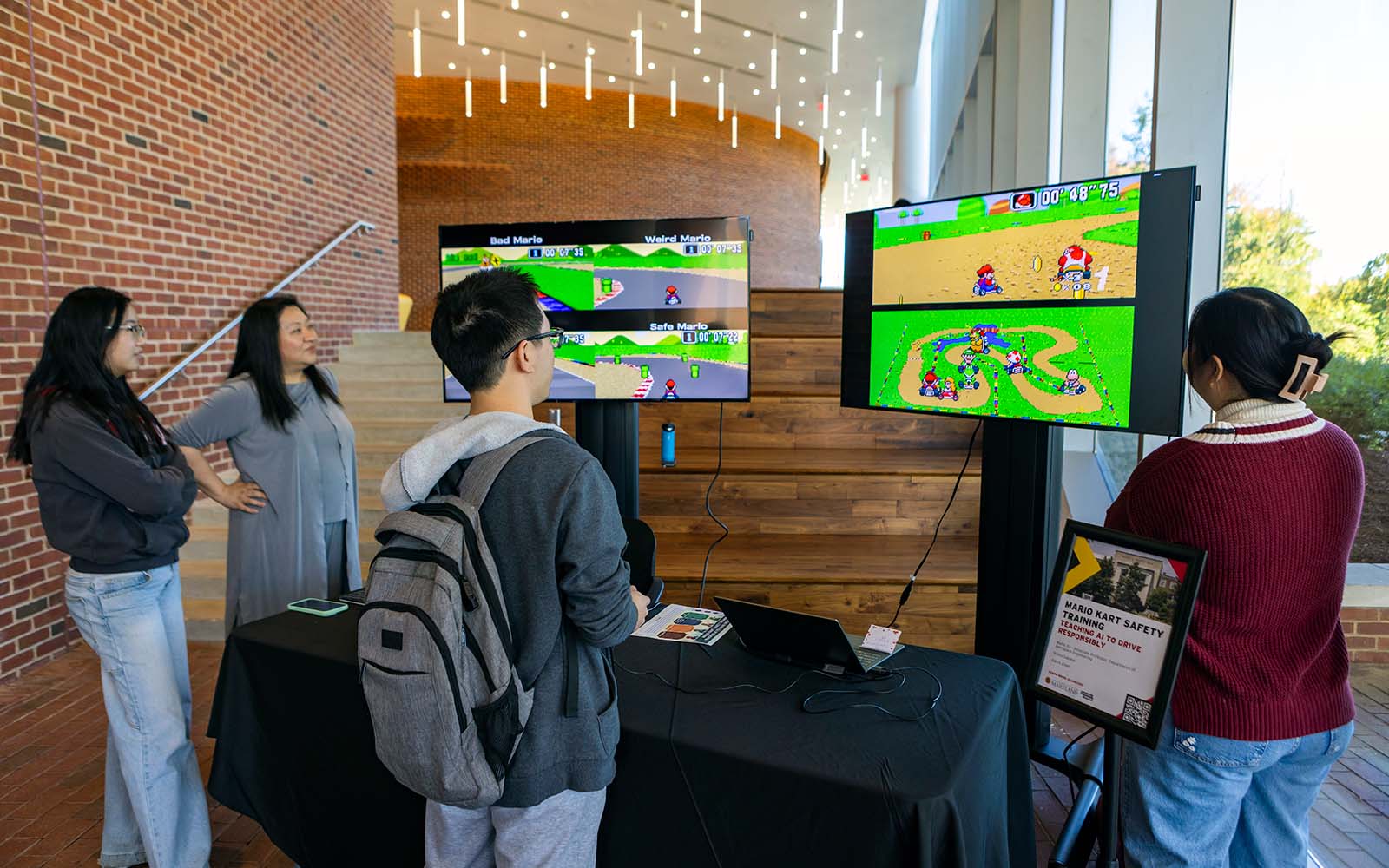 During AI Demo Day, Mumu Xu observes a student racing her AI-trained Mario Kart driving