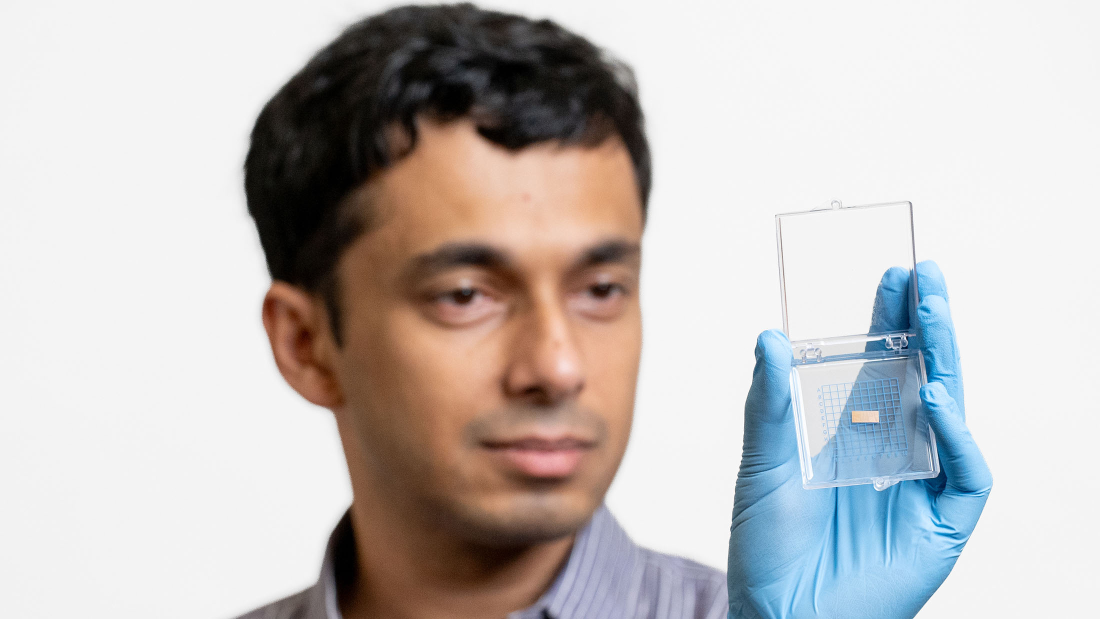 Avik Dutt presents a computer chip within a protective case