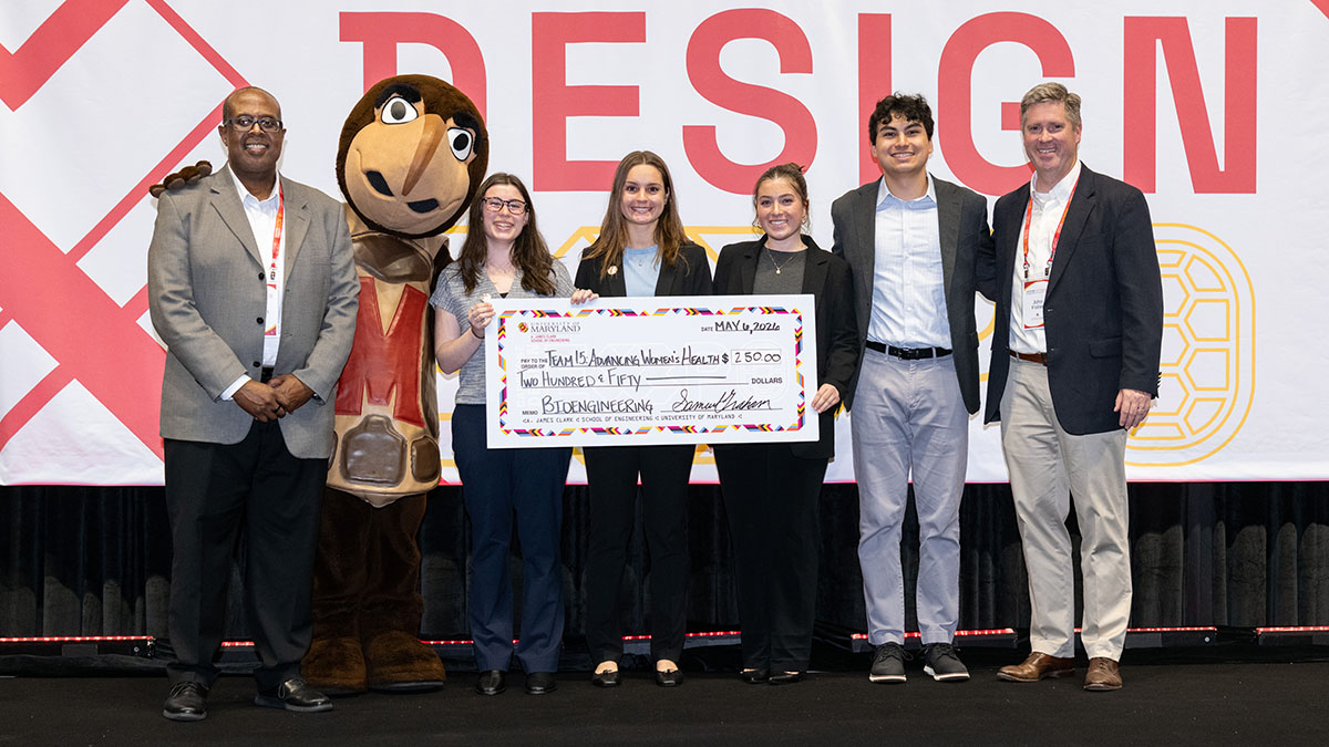 BIOE students hold a giant check for $250