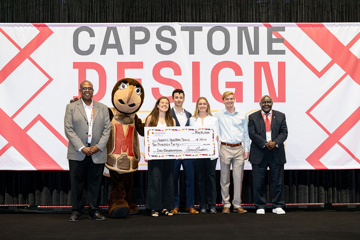 CEE students pose with a giant $250 check