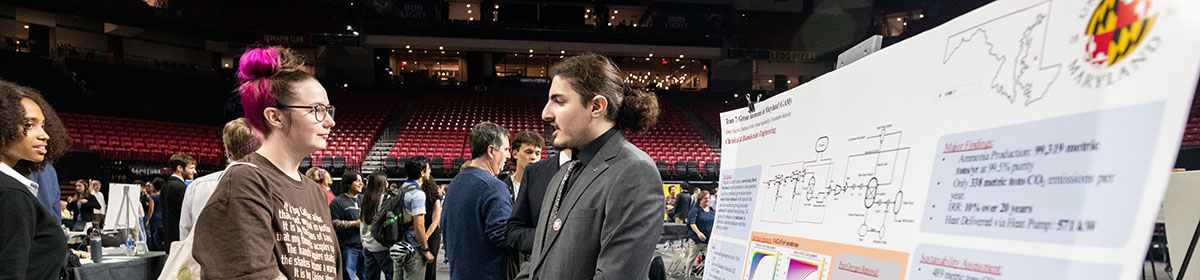 A ChBE student explains his research to an attendee