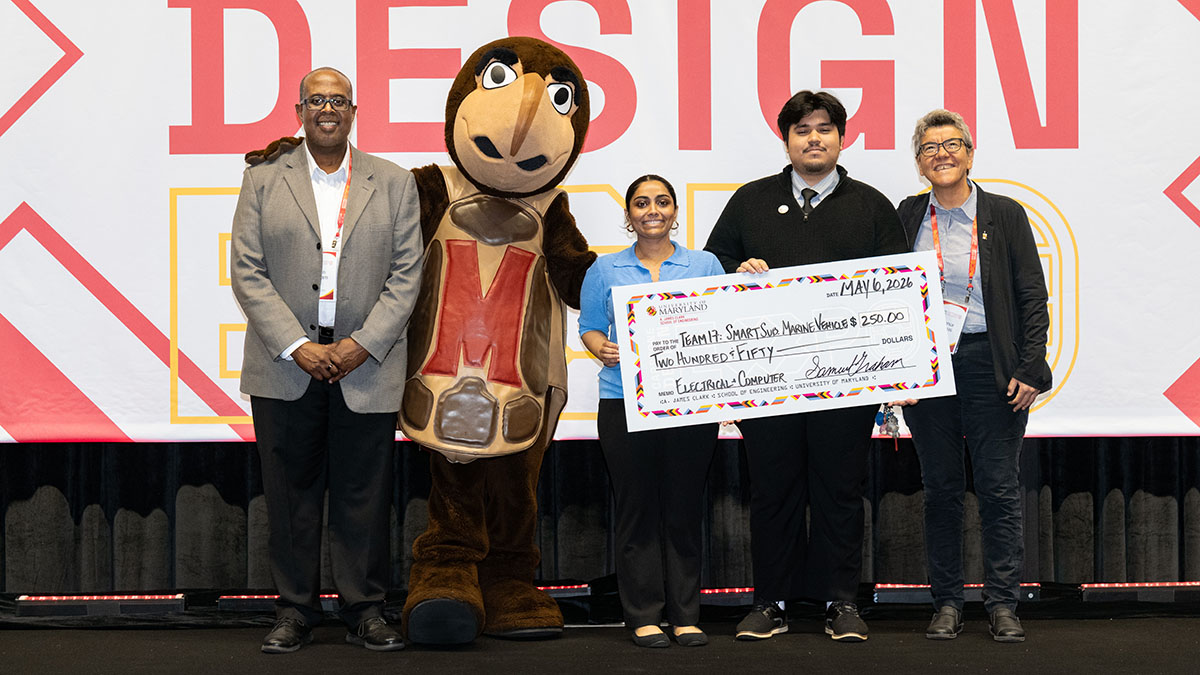 ECE students hold a giant check for $250