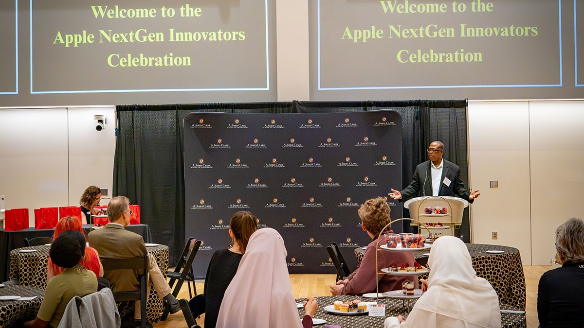 Dean Graham addresses people seated at tables