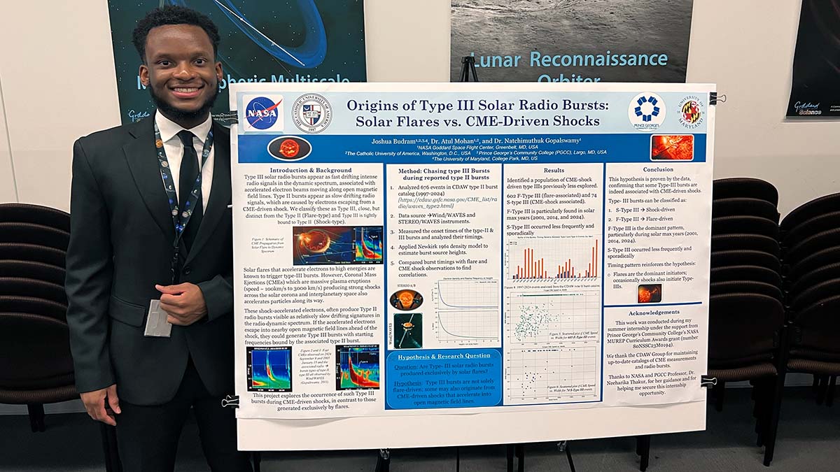 Joshua Budram stands in front of his research poster