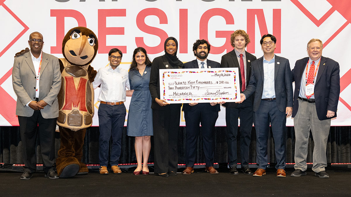 ME students hold a giant check for $250