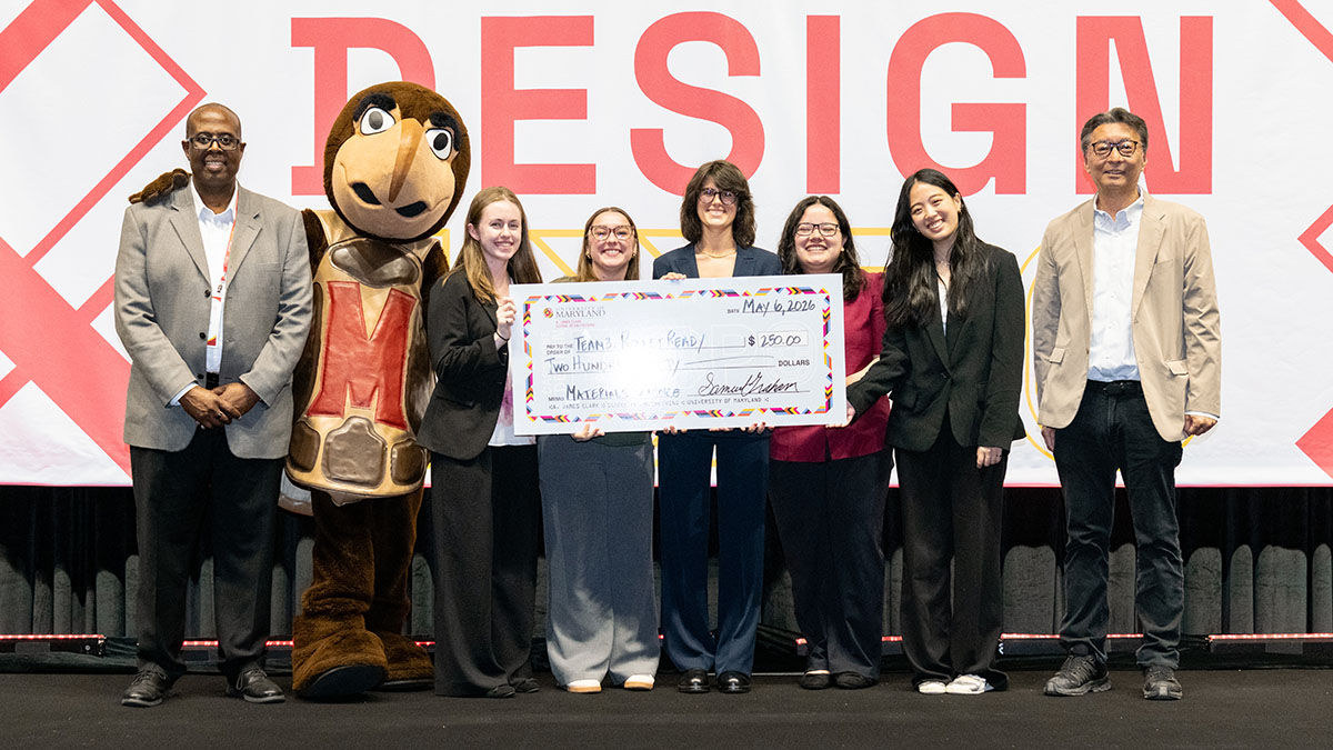 MSE students hold a giant check for $250