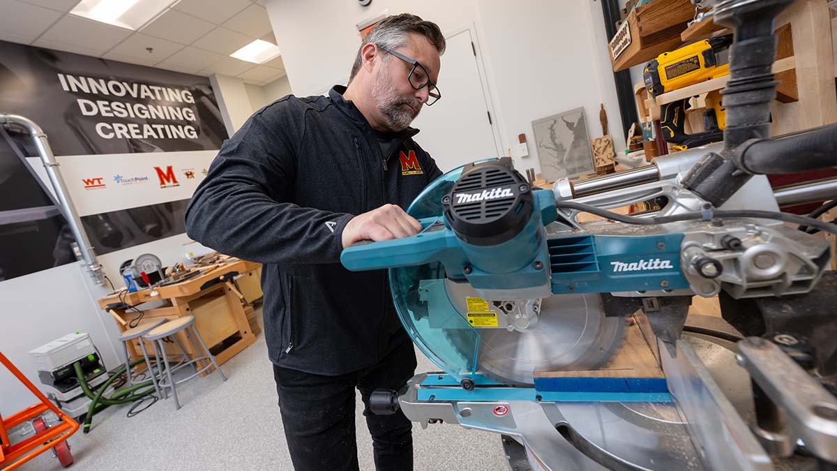Man uses a circular saw to cut wood