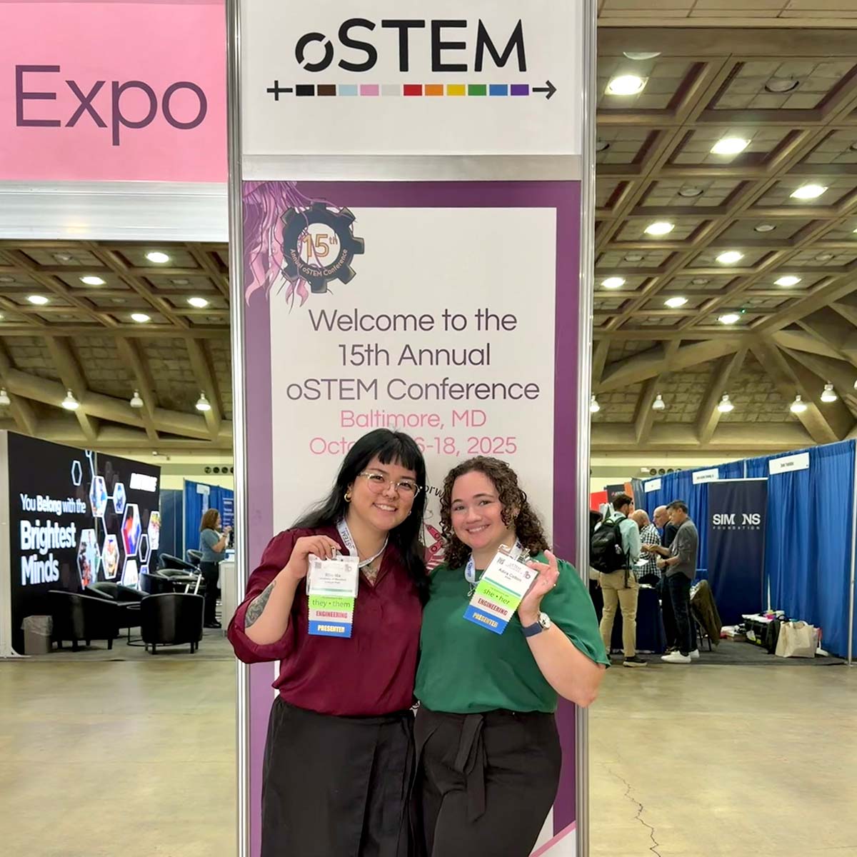 Rho Ma holds up her oSTEM conference badge